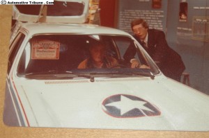 Automobile racing team member sizes up the Solar-Thermal Car.  At right is Vice-President of American Solar, Richard Kubis.
